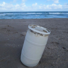 Plastic Pollution 35 gallon plastic drum washed ashore