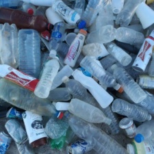 Plastic is Forever Pile of plastic bottles and other items on beach