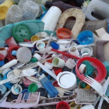 Plastic Bites Pile of plastic bottles and containers on beach