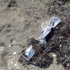 Balloon Pollution mylar buried in beach sand