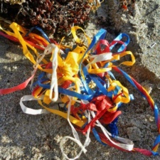 Balloon Ribbon & Bits of Latex Balloons pile of balloon ribbon and broken latex balloons polluting beach